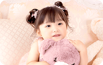 クマのぬいぐるみを抱きしめる女の子
